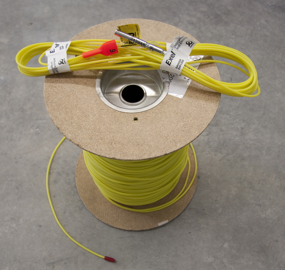 Non-electric detonator on a spool of shock tube lead-in line