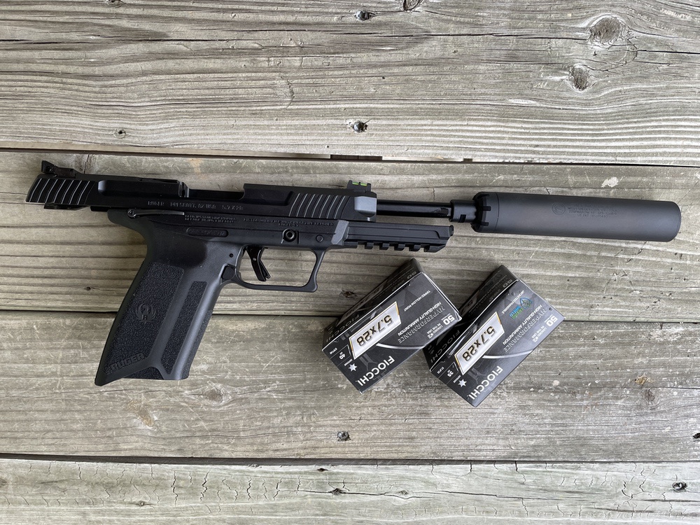 Ruger-57 on bench with ammo and silencer